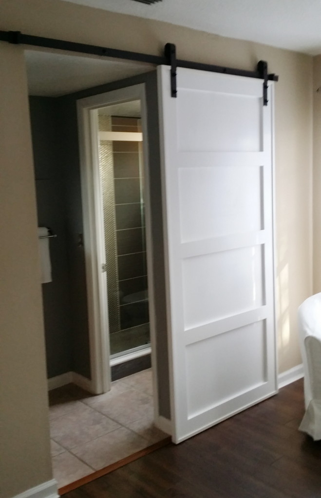 A barn door provides privacy and is a great architectural feature